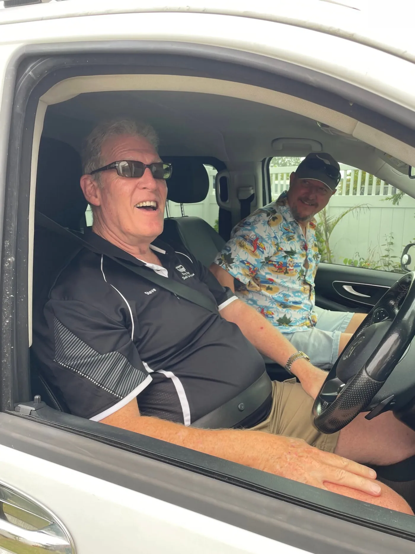 Two Hervey Bay Shuttle Bus Service drivers standing beside their shuttle bus in Hervey Bay