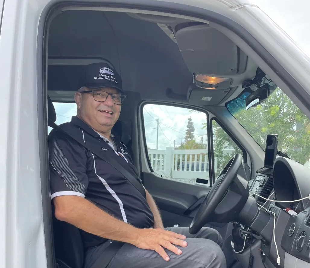 Hervey Bay Shuttle Bus Service driver seated at the wheel of the shuttle bus in Hervey Bay