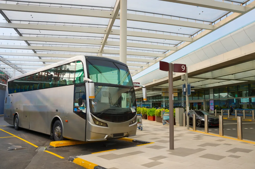 Hervey Bay Shuttle Bus Service coach parked outside the Brisbane Airport terminal for a transfer