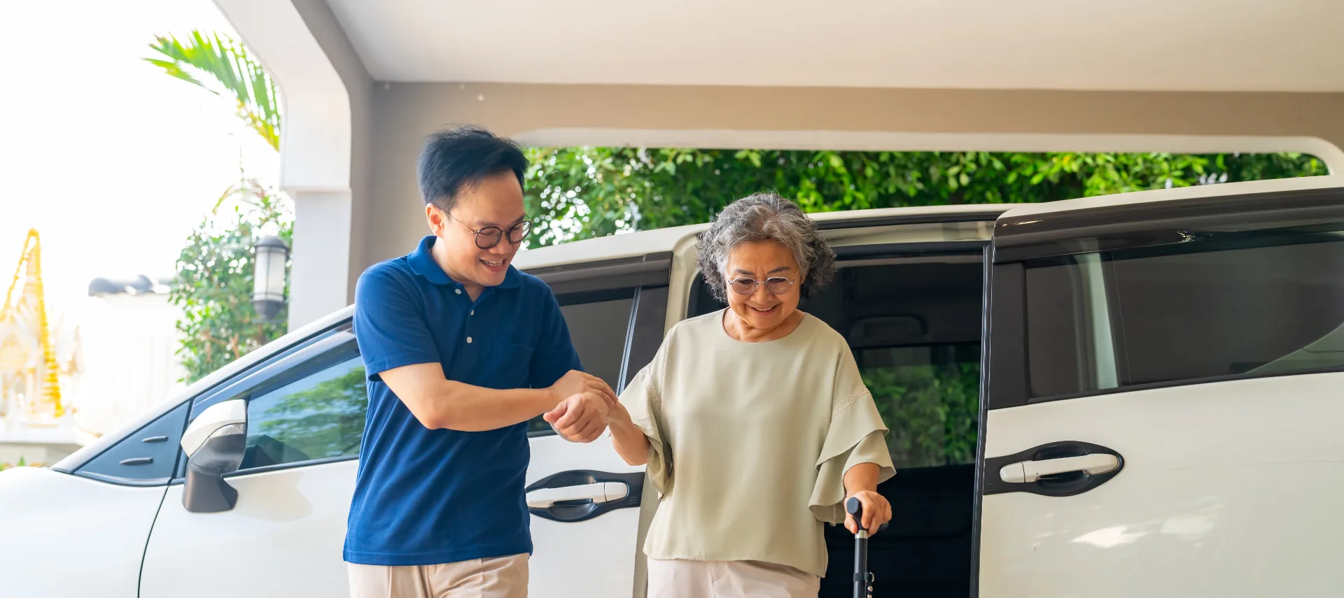 Driver assisting an elderly passenger boarding the Hervey Bay Shuttle Bus Service medical transport van
