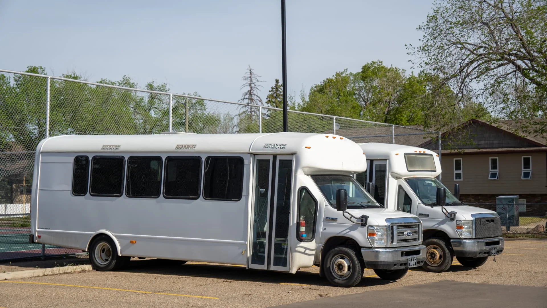 Row of shuttle buses in a Hervey Bay depot lot used for FIFO transport runs