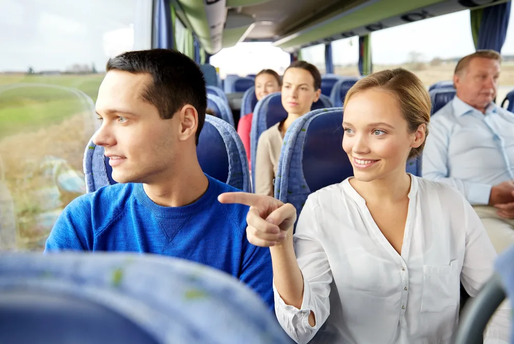 Passengers chatting on board a Hervey Bay Shuttle Bus Service charter bus during a group trip